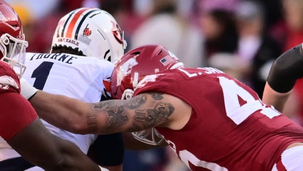 Razorbacks defensive lineman Landon Jackson delivers a hit on Auburn quarterback Payton Thorne